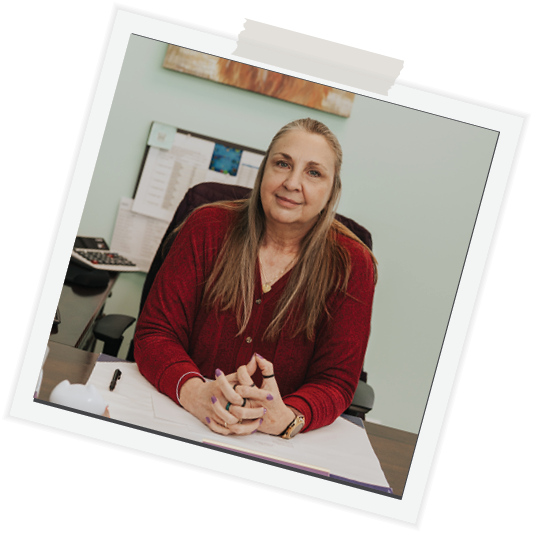 polaroid-rotated-forty-five-degrees-woman-straigh-blond-hair-in-blouse-sitting-at-desk