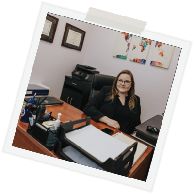 polaroid-rotated-forty-five-degrees-woman-blond-short-hair-in-suit-sitting-at-desk